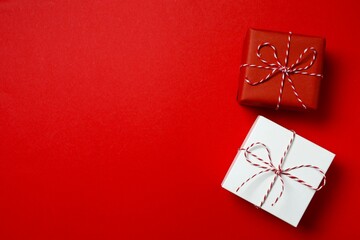 Beautiful gift boxes tied with bows on color background 