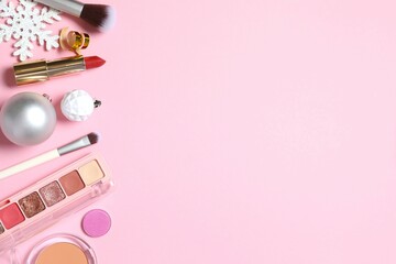 Flat lay composition with makeup products and Christmas decor on color background