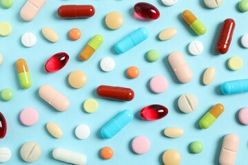 Various medicine pills on color background 