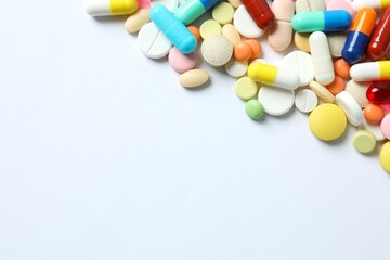 Various medicine pills on color background 