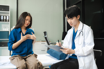 Fototapeta premium woman patient filling insurance legal document at appointment with doctor. woman patient signing medical treatment contract, agreement form for taking medic care service, consultation, therapy