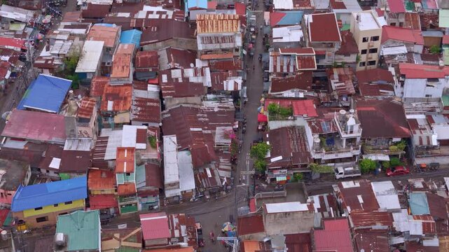 Top down aerial view of squalid poverty stricken slums lining Cebu City's downtown aera.