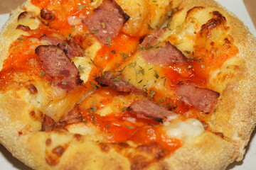 Pizza is a popular Italian dish that has become a global favorite. It's made by baking a round, flat base of dough topped with various ingredients such as cheese, tomato sauce