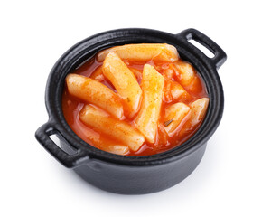 Tteokbokki rice cakes with chilli sauce isolated on white background. Korean cuisine dish.