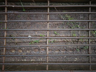 The fence of the drainage channel that has begun to rust and get wet after being showered with rain in the morning