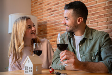 Happy Couple Toasting with Red Wine in a Modern Kitchen