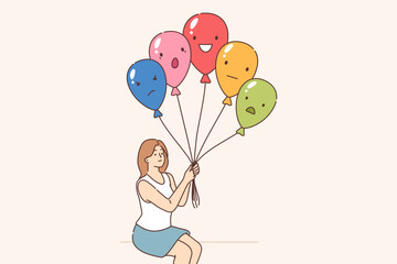 Emotional control is practiced by woman holding balloons with positive or negative grimace