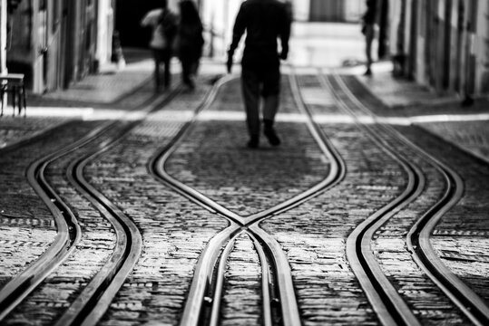 Tourists walking at the ascensor tracks at Bica de Duarte Belo street in old town Lisbon