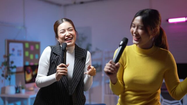 Joyful office colleagues singing and laughing together in karaoke session - Powered by Adobe