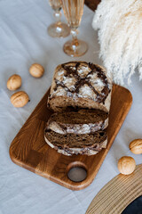 A freshly baked loaf of delicious bread is sitting on a rustic wooden cutting board, ready to be sliced and enjoyed. It looks perfect for sandwiches or toast any time of day