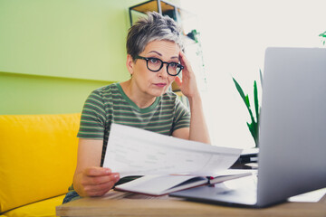Photo of charming pensioner lady stressed tired problem work papers dressed green garment house...