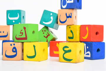 Fototapeta premium Wooden Arabic Alphabet Blocks isolated on white background. Arabic Alphabet Cubes. Preschool and education concept. Copy space