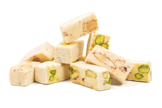 Italian torrone nougat candy blocks with almonds and pistachios isolated