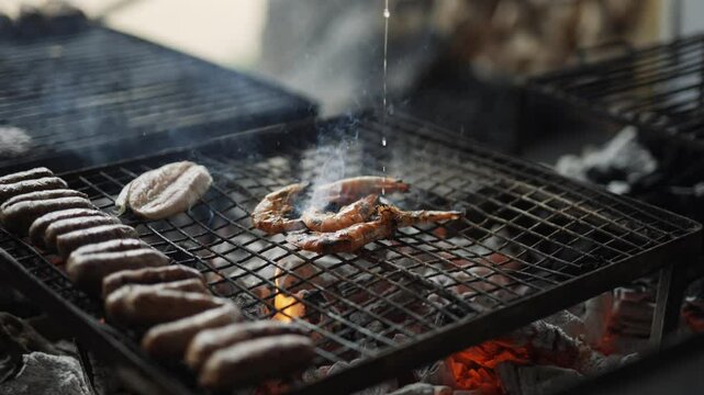 A person squeezing lemon on a grilled prawn mean on a grill
