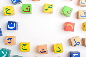 Wooden Arabic Alphabet Blocks isolated on white background. Arabic Alphabet Cubes. Preschool and education concept. Copy space, flat lay