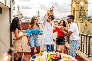Man dancing with friends in rooftop during birthday party