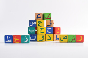 Wooden Arabic Alphabet Blocks isolated on white background. Arabic Alphabet Cubes. Preschool and education concept. Copy space