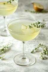 Refreshing cocktail with pear slices and thyme garnishes in elegant glass, exuding sophisticated and fresh vibes on a light surface.