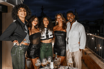 Portrait of a group of multi-ethnic friends partying at night