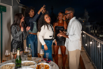 Happy people celebrating life together in a roof night party