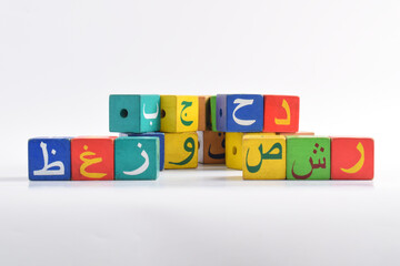 Wooden Arabic Alphabet Blocks isolated on white background. Arabic Alphabet Cubes. Preschool and education concept. Copy space