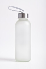 Glass sport water bottle with metal top isolated on white background