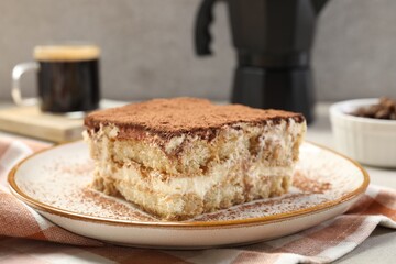 Piece of tasty tiramisu on table, closeup