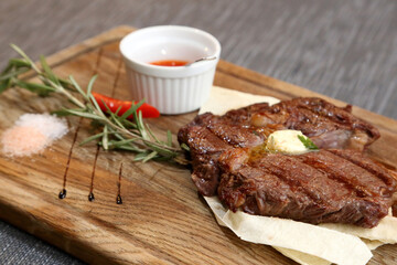 Beef steak on a wooden board.
