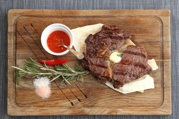 Beef steak on a wooden board.