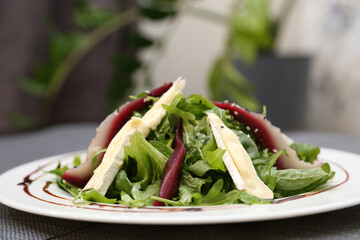 Pear salad with herbs. Pear salad on a white plate.