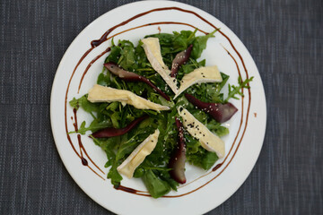 Pear salad with herbs. Pear salad on a white plate.
