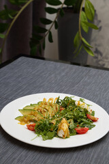 Avocado salad with cheese and herbs on a white plate. Avocado salad with cheese.