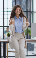 Proud office worker posing with thumbs up