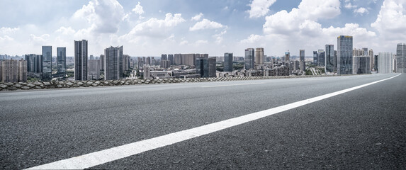 Expansive Cityscape with Open Road and Dramatic Sky