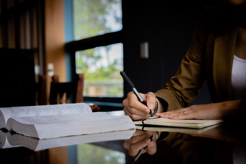 Professional writing using a legal notepad and desk. Signing a form in an office, official document
