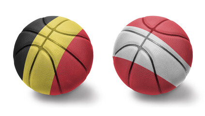 basketball balls with the national flags of austria and belgium on the white background.