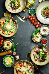Food. Set of dishes and spices on the table, table setting, dining table. On a dark stone background. free space for text.