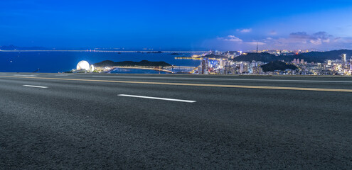 Serene Coastal Cityscape at Dusk with Scenic Road Perspective