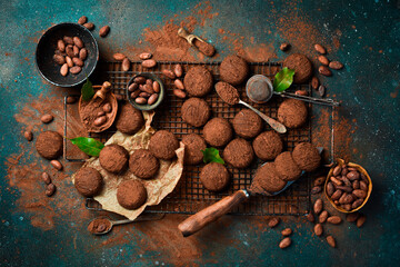 Chocolate candies, truffles, chocolates and cocoa beans. Sweets, pastries, brownies On a dark...