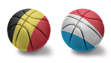 Obraz premium basketball balls with the national flags of luxembourg and belgium on the white background.