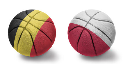 Obraz premium basketball balls with the national flags of poland and belgium on the white background.