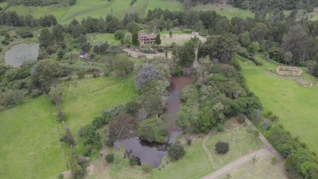 The camera glides over verdant gardens and winding trails that weave through dense forests, capturing the diversity of flora that thrives here. Short gimbal tilt down, roll right with yaw left.