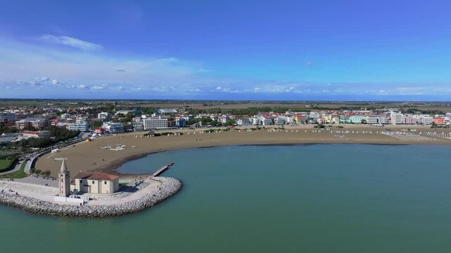 aerial journey past coastal Madonna dell'Angelo church and toward the Levante Beach Caorlefornia