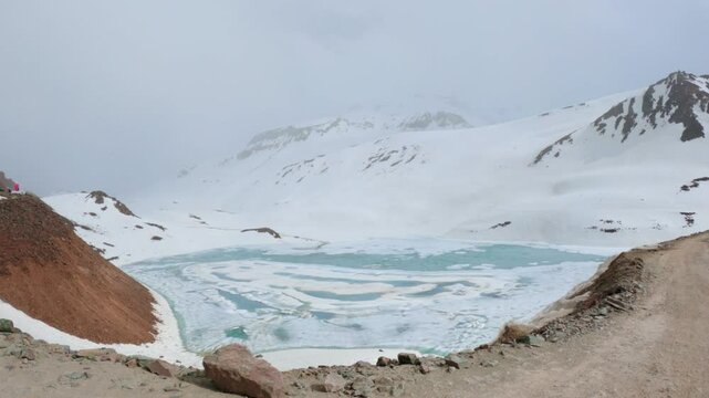 4K shot of frozen Suraj Tal lake as seen on the way towards Bara Lacha La Pass in Lahaul and Spiti district, Himachal Pradesh, India. Frozen lake due to the cold temperatures in winter season.	