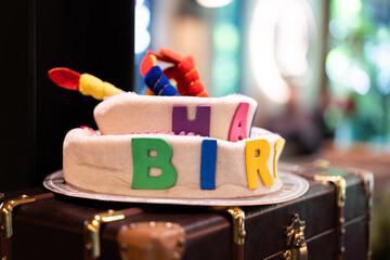 Birthday party hat on vintage box bokeh light background