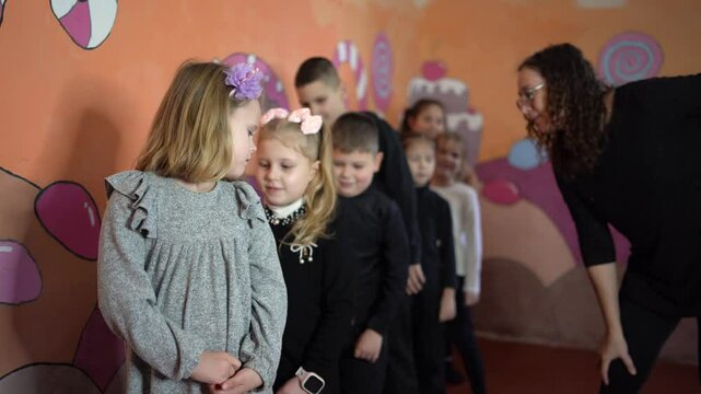  5-7 year old children at an acting class with their teacher, extracurricular activities