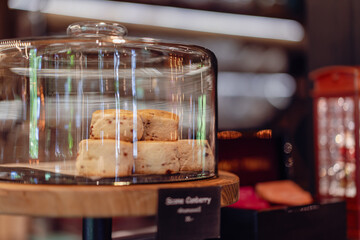 Sweets on the front of a small coffee shop, bokeh light background