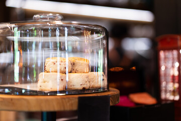 Sweets on the front of a small coffee shop, bokeh light background