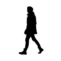 a silhouette of a person walking in a stylish trench coat and boots
