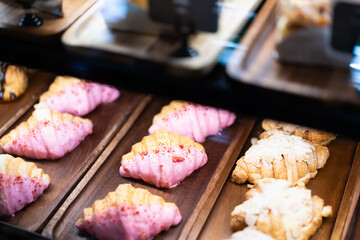 Cakes and sweets on the front of a small coffee shop, bokeh light background